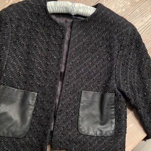 Boucle Chanel style jacket with faux leather pockets.